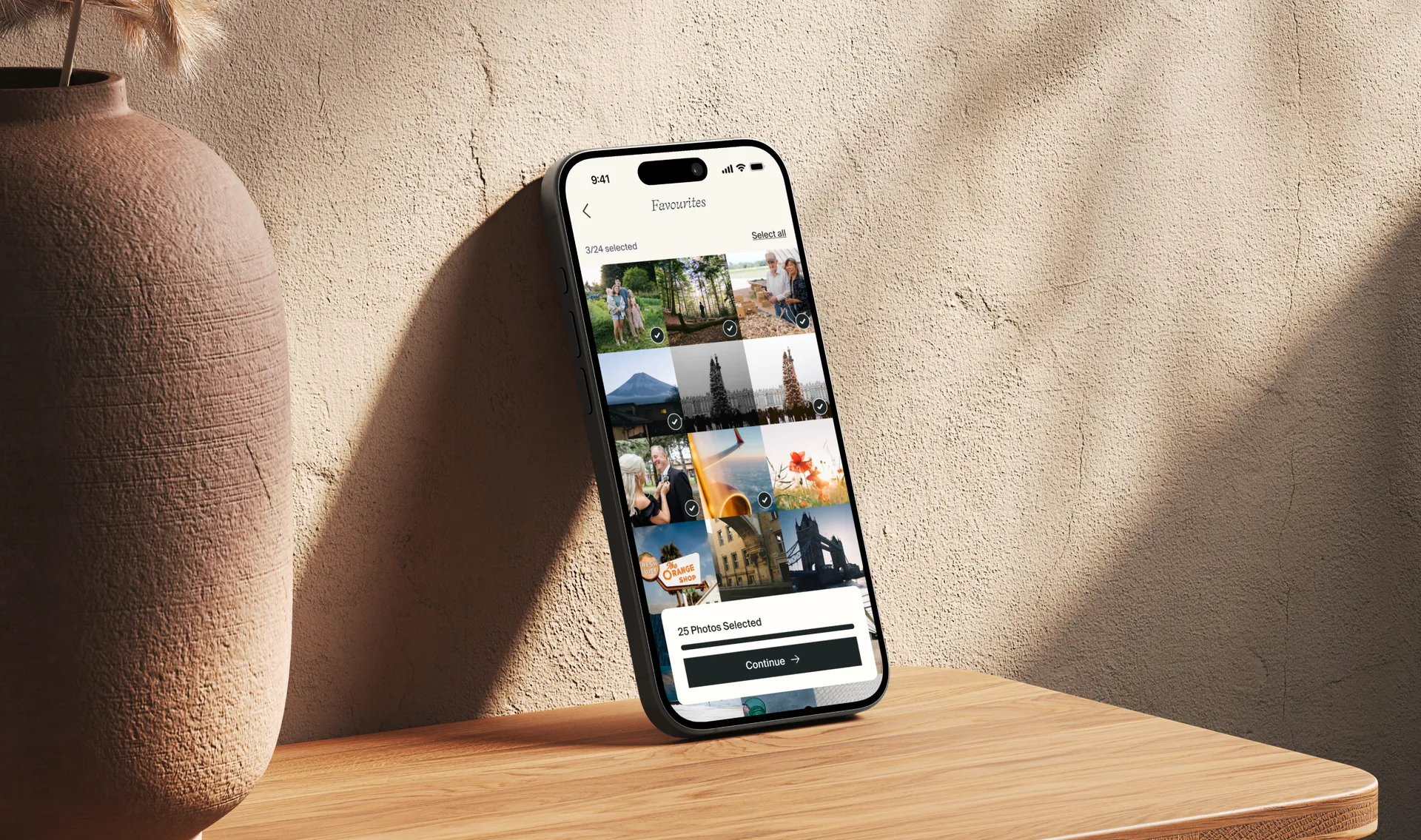 Phone leaning on a wall showing a photo gallery app