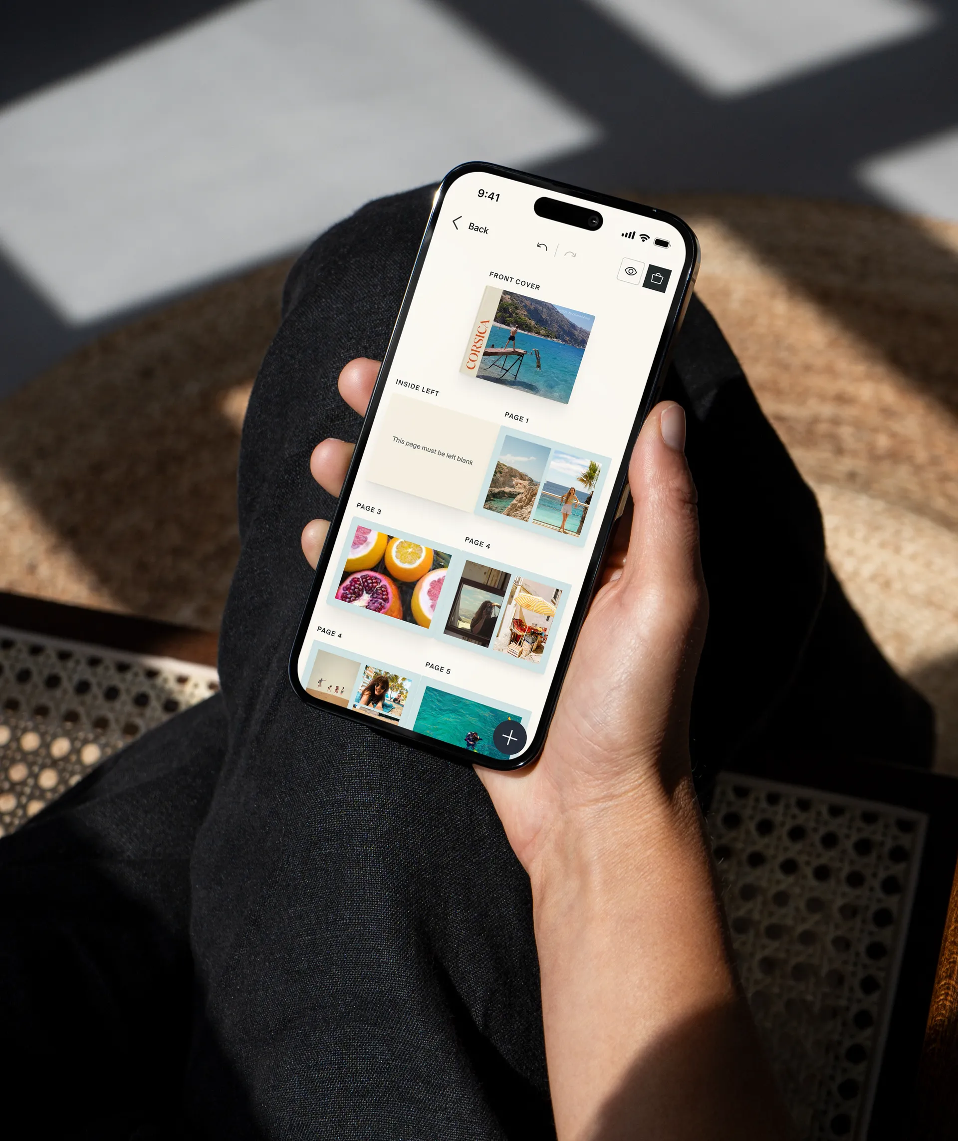 Hand holding a phone with a photo app