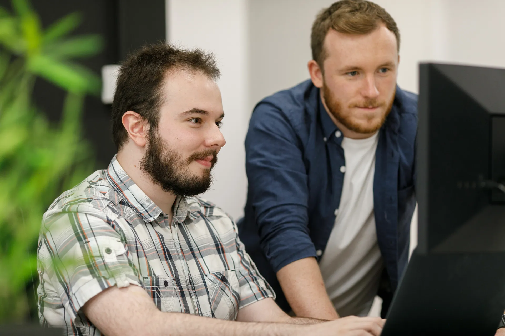 Two developers looking at a screen together