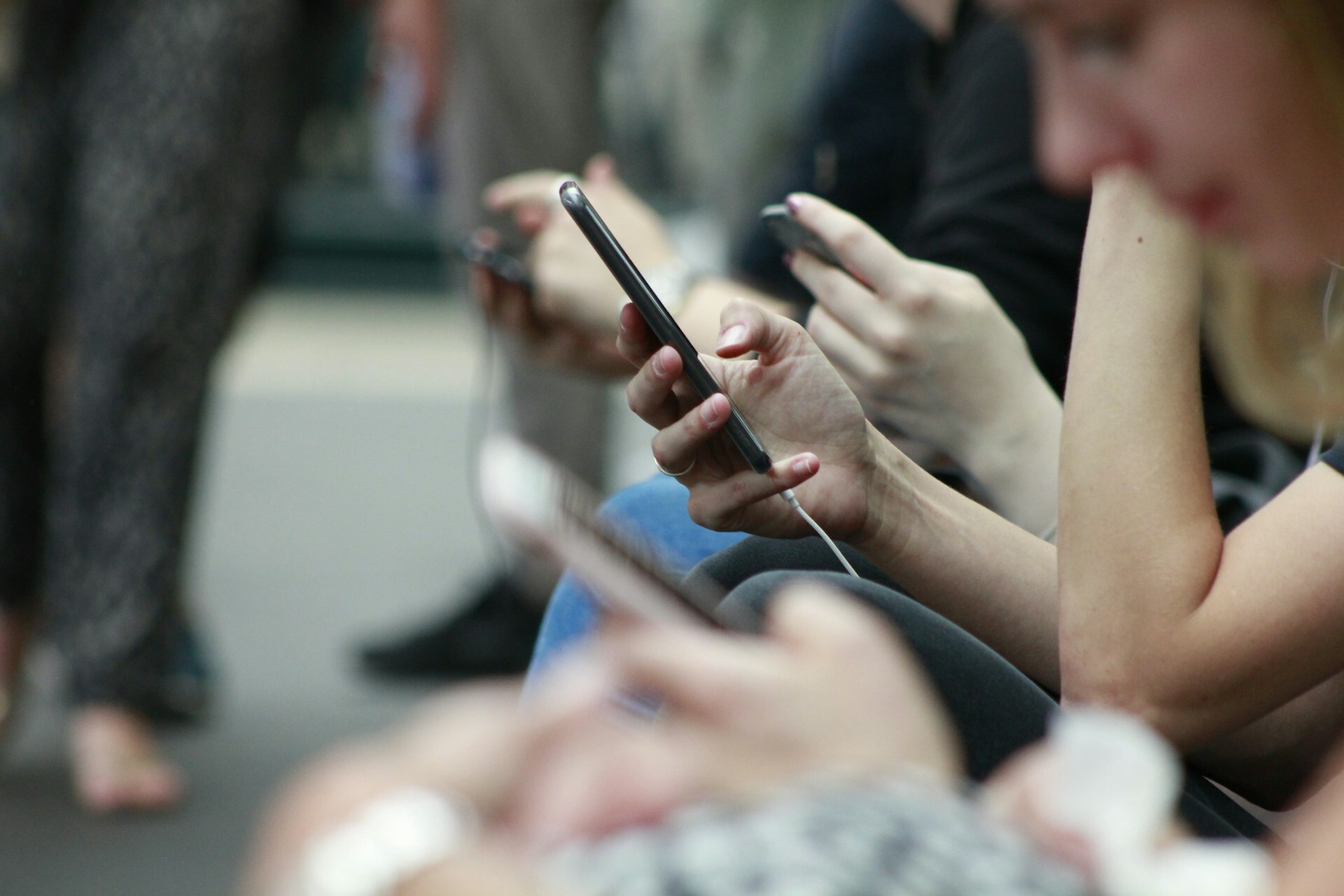 People sat down using phones