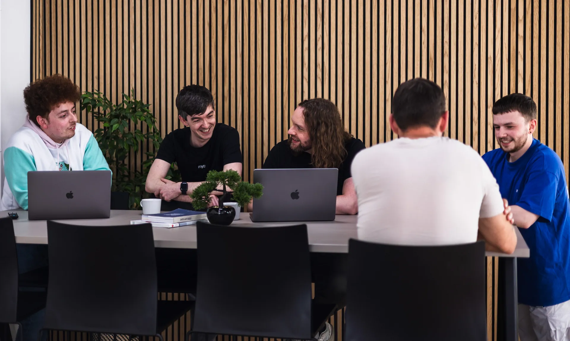 The Myth team meeting around a table