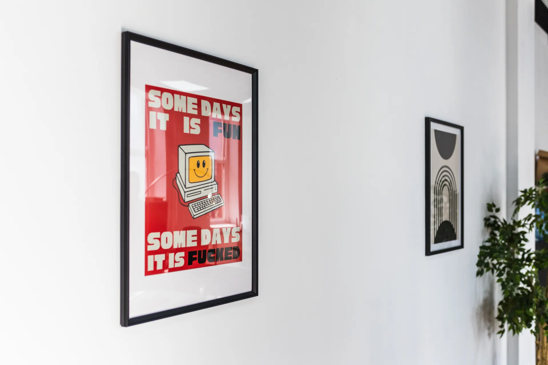 Framed posters on a white wall