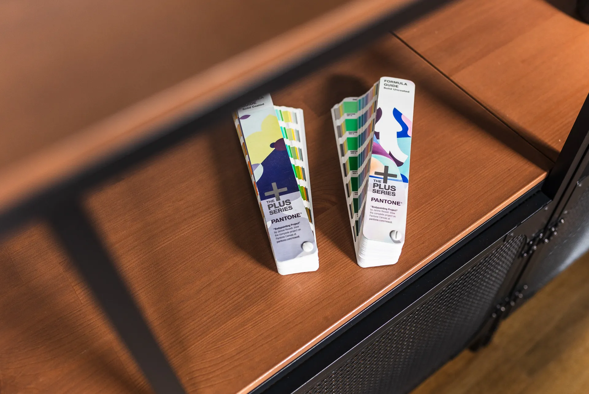 Colour swatch books on a wooden ledge